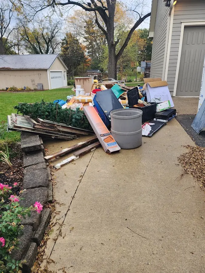 Dumpster being loaded with debris for 12 Yard Dumpster Rental in Rutland